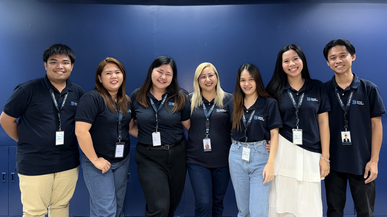 The client relations team standing together in Better Practice polo shirts