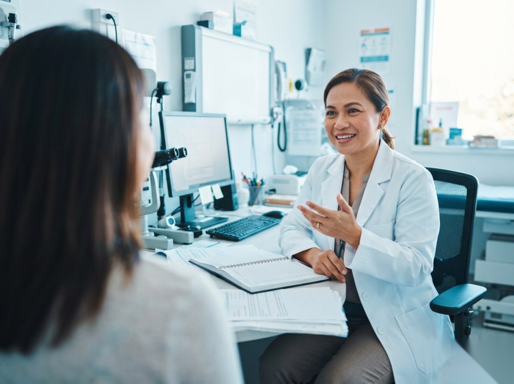 An established doctor mid-consultation in a busy clinic