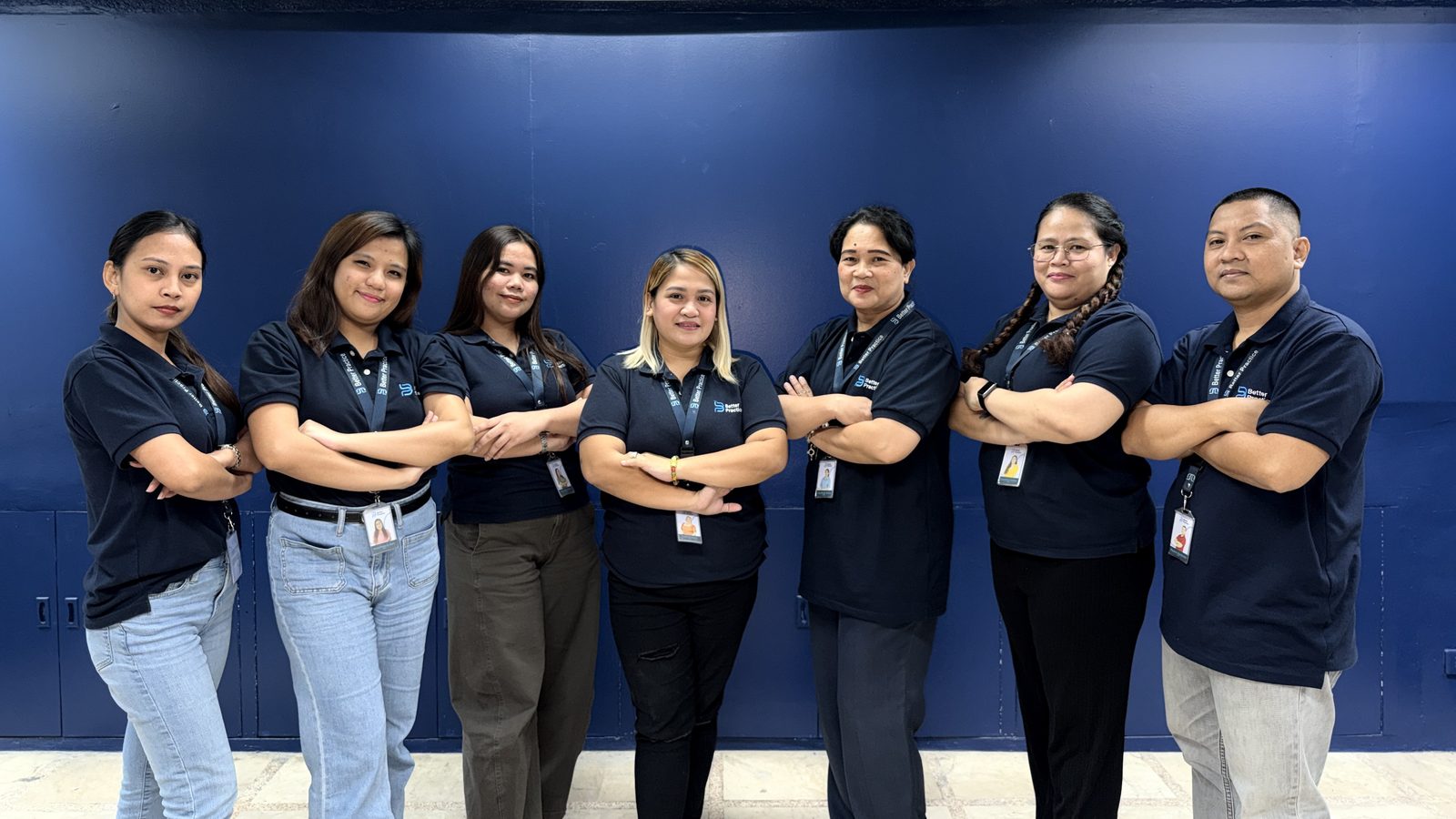 The operations team standing with arms folded in Better Practice polo shirts